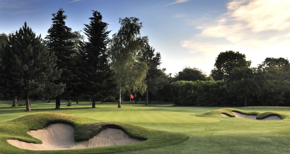 3 Hammers Golf Complex, Staffordshire, - View of golf course from behind green with 2 bunkers and trees lining the backdrop