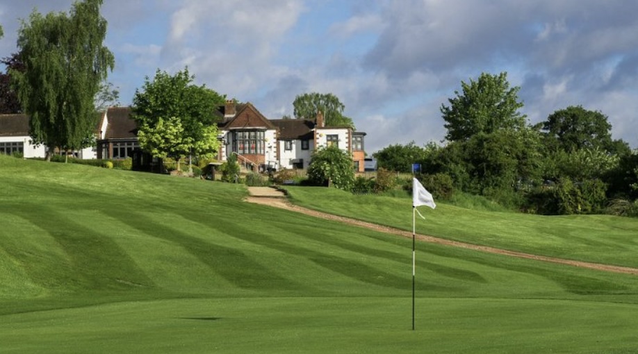 Addington Court Golf Club, Surrey, - view of golf course from green with flag and path leading up to clubhouse