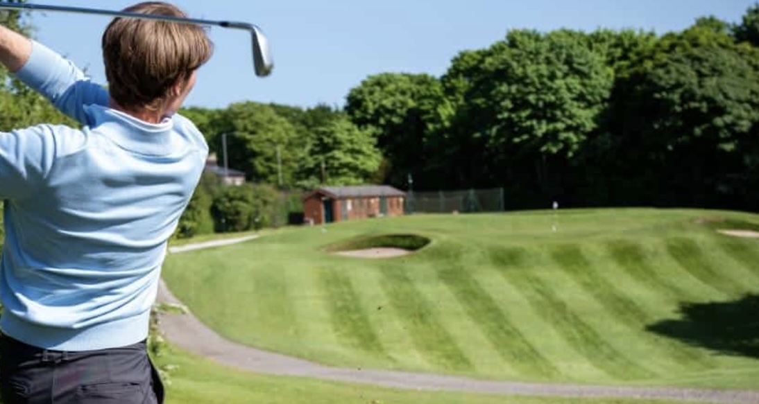 Golf Club England- Allerton Golf Course, Merseyside,UK - Golf Vouchers Allerton Golf Course, Merseyside - View with golfer on tee , fairway and flg in the distance
