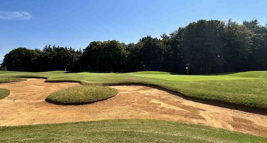 Bowood Golf Club, Wiltshire - view of golf course from behind green with large bunker and trees lingin the backdrop