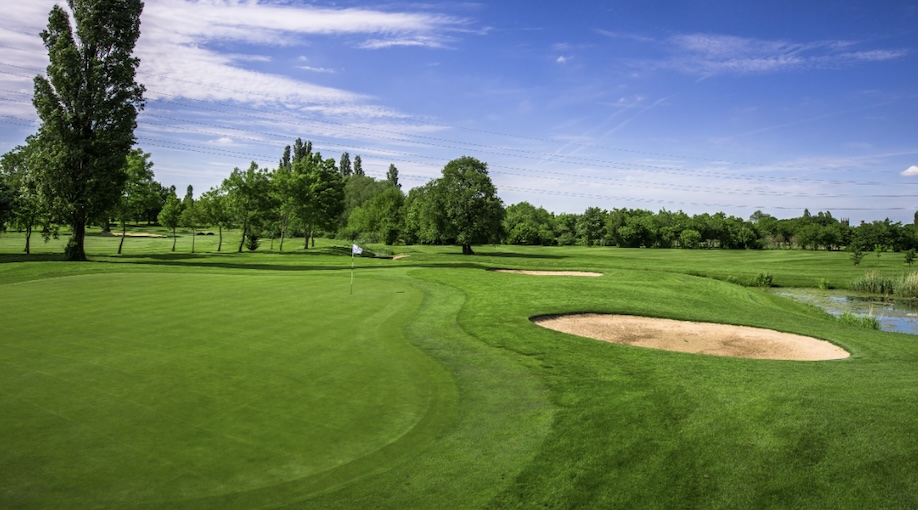Branston Golf & Country Club, Staffordshire, - View on green of golf course with bunkers and samll pond water feature