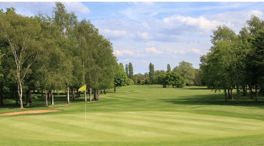 Cambridge Golf & Country Club, Cambridgeshire - view of golf club green and tree lined fairway