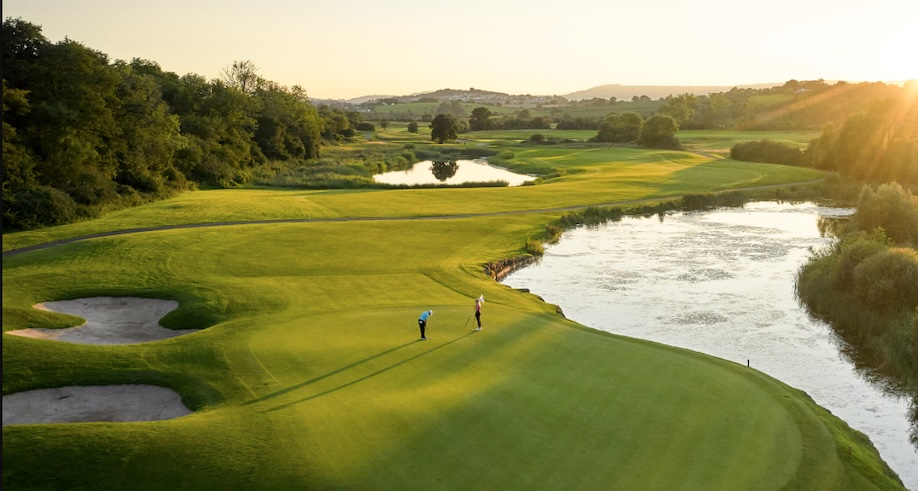 Golf Club Wales - Celtic Manor Golf & Country Club, Monmouthshire, UK - Golf Vouchers Celtic Manor Golf & Country Club, Monmouthshire, - aerial view across golf course green and fairway with 2 large water features and bunkers, rolling countryside in distance