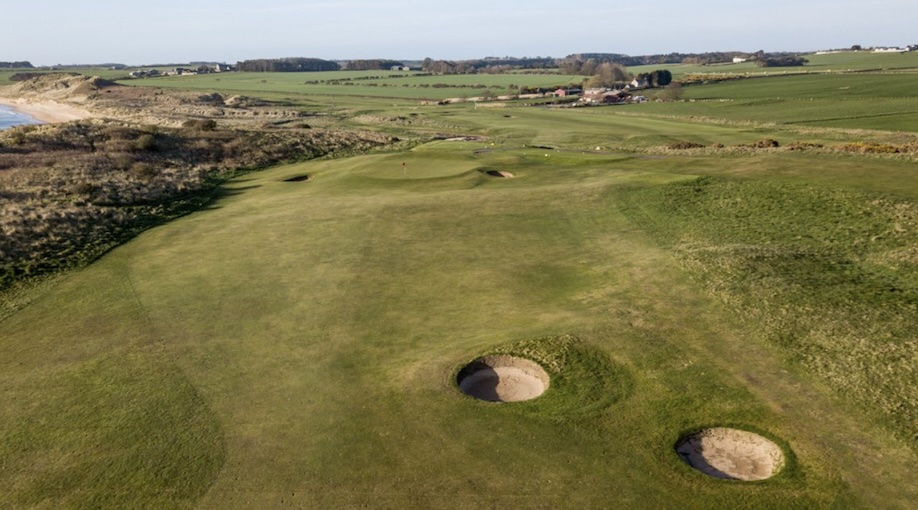 Dunstanburgh Castle Golf Club, Northumberland - aerial view of golf course with open land coastal location, grrens, fairways and bunkers