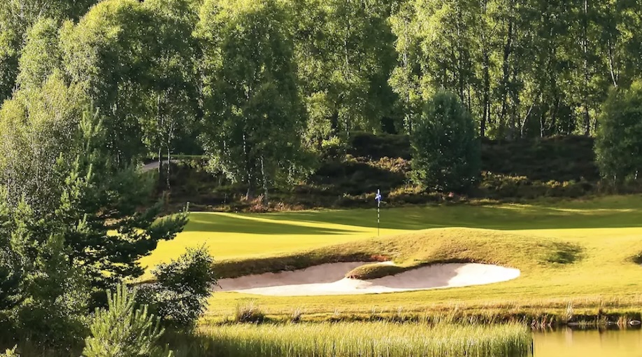 Hill Valley Golf & Country Club, Shropshire - View of golf course from across lake back to green with bunker to front and trees behind