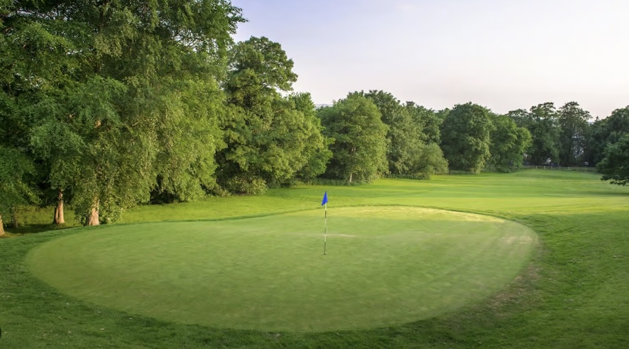 Hoebridge Golf Centre, Surrey, - view of golf course from behind green looking back down tree lined fairway to tee