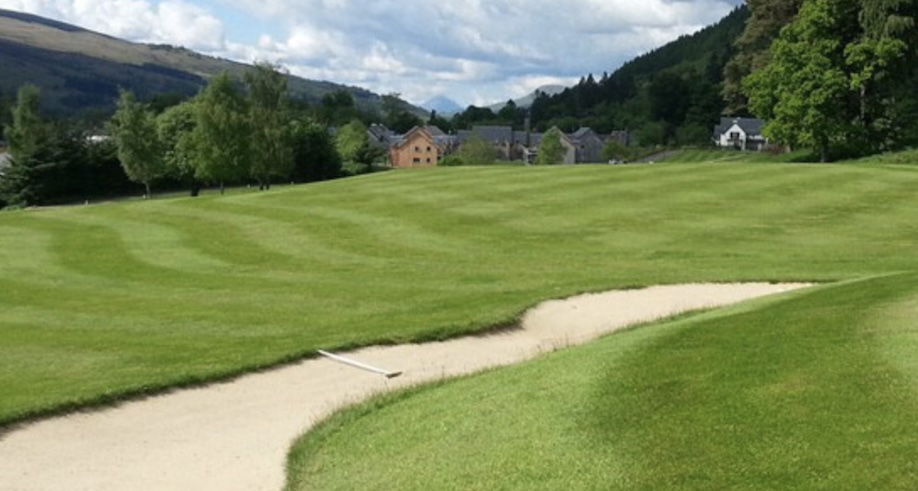 Mains of Taymouth Golf Club, Perthshire - landscape view of golf course fairway and green with buildings and mountains in far distance