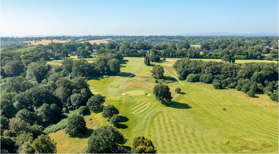 Mannings Heath Golf Club, East Sussex - Aerial view of golf course fairways, greens and bunkers. Rolling countryside in the distance