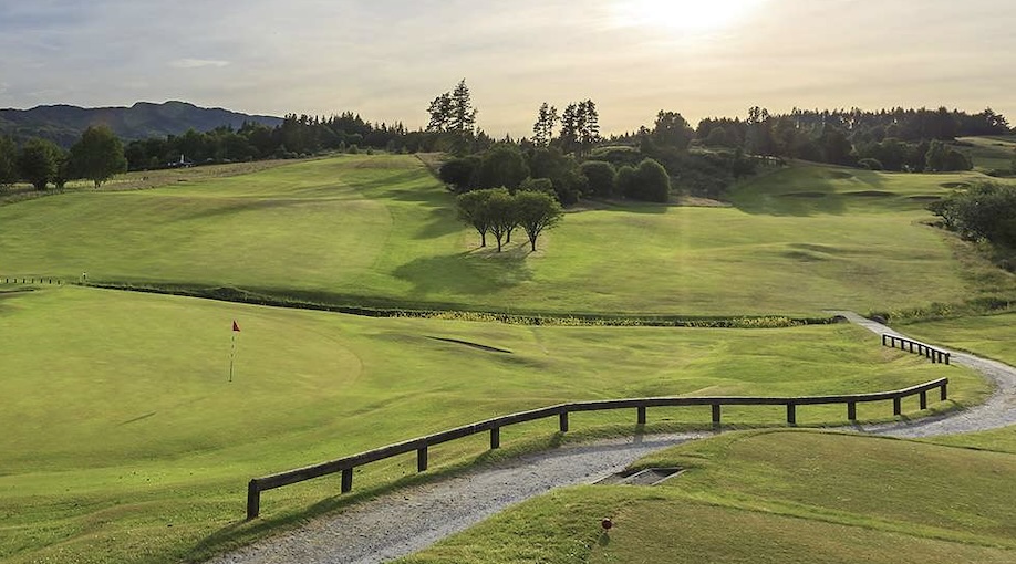 Pitlochry Golf Course, Perthshire - View of golf course fairways and greens with fenced path running through and trees in the distance