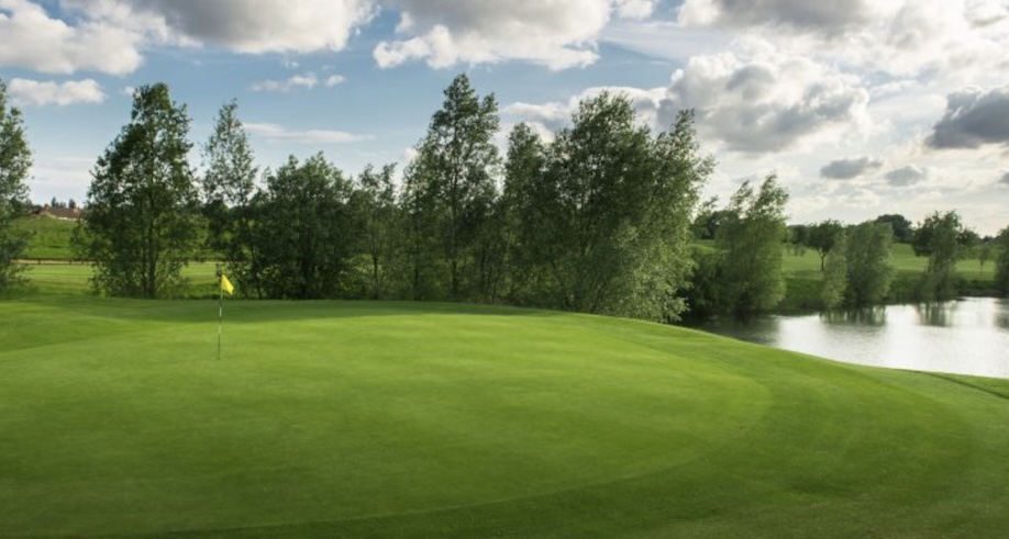 Sunbury Golf Club, Middlesex - view of golf course on green with small tress and pond