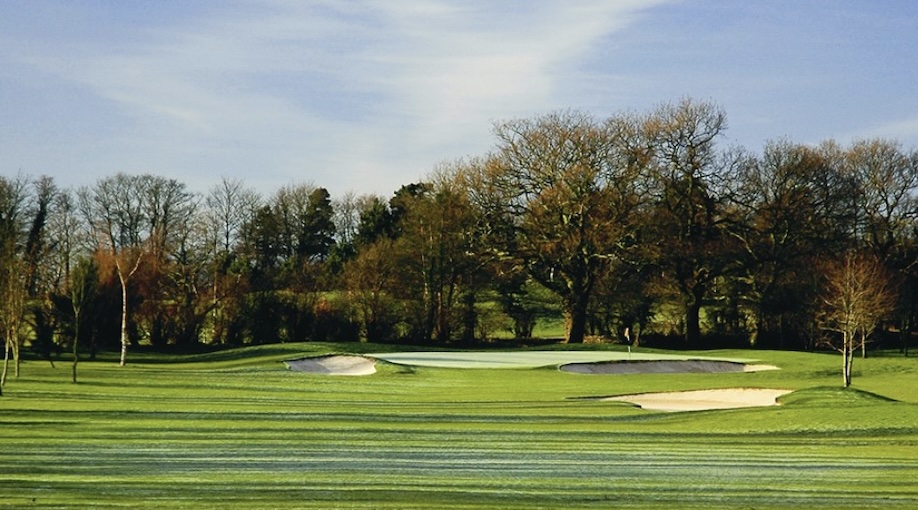 The Belfry, West Midlands, UK - View of golf course from tee looking down fairway to green with bunkers around and trees lining the backdrop