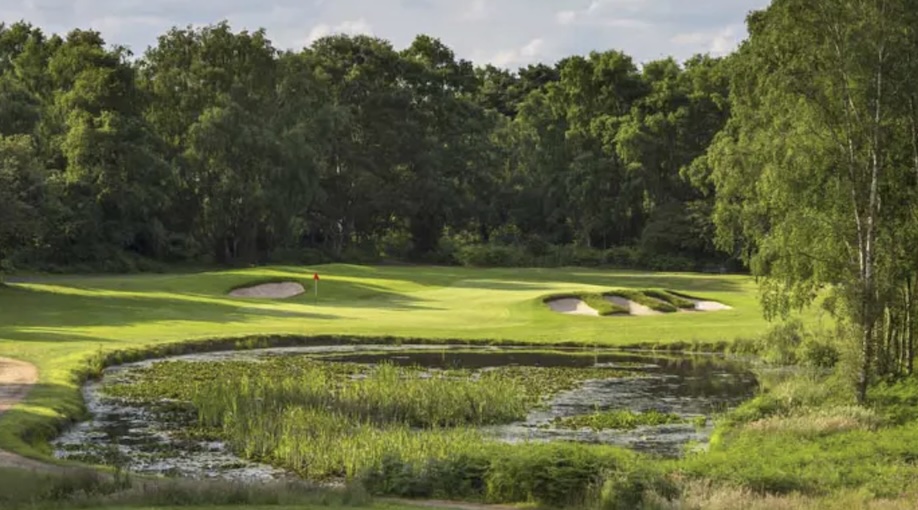 Thorpeness Golf Club, Suffolk, - view across lake to golf course green surrounded by tress and with bunkers