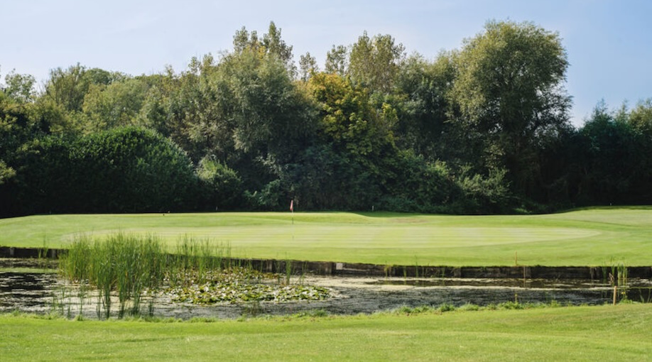Golf Club England - Wrag Barn Golf & Country Club, Wiltshire, UK - Golf Vouchers Wrag Barn Golf & Country Club, Wiltshire - View of golf course green from tee looking over lake and fairway