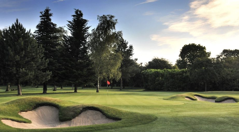 3 Hammers Golf Complex, Staffordshire, - View of golf course from behind green with 2 bunkers and trees lining the backdrop