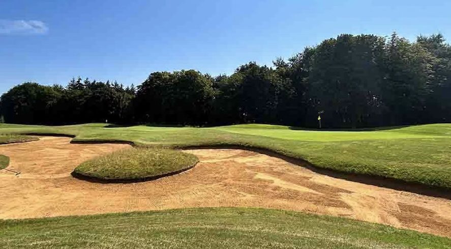 Bowood Golf Club, Wiltshire - view of golf course from behind green with large bunker and trees lingin the backdrop