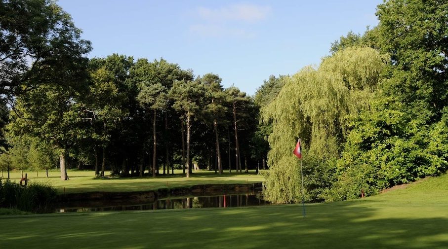 St Ives (Hunts) Golf Club, Cambridgeshire - view of golf course from green looking across small lake to tree lined fairway